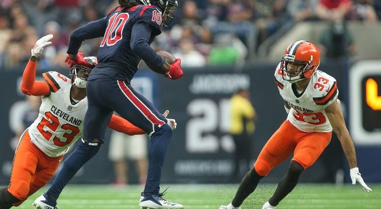 Dec 2, 2018; Houston, TX, USA; Houston Texans wide receiver DeAndre Hopkins (10) runs with the ball as Cleveland Browns strong safety Damarious Randall (23) and cornerback Phillip Gaines (33) defend during the game at NRG Stadium.